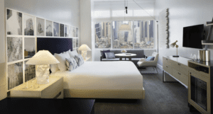 A bedroom with a view of the city.