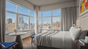 A hotel room with a view of the city.