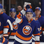 The new york islanders celebrate after scoring a goal.