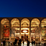 The new york metropolitan opera building at night.