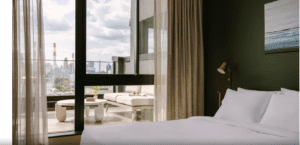 A hotel room with a view of the city.