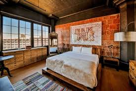 A bedroom with brick walls and a large bed.